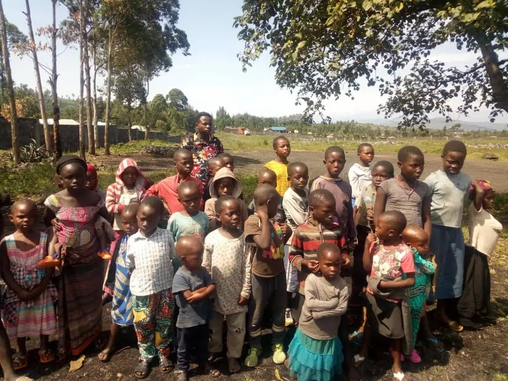 Village children gathered under the trees