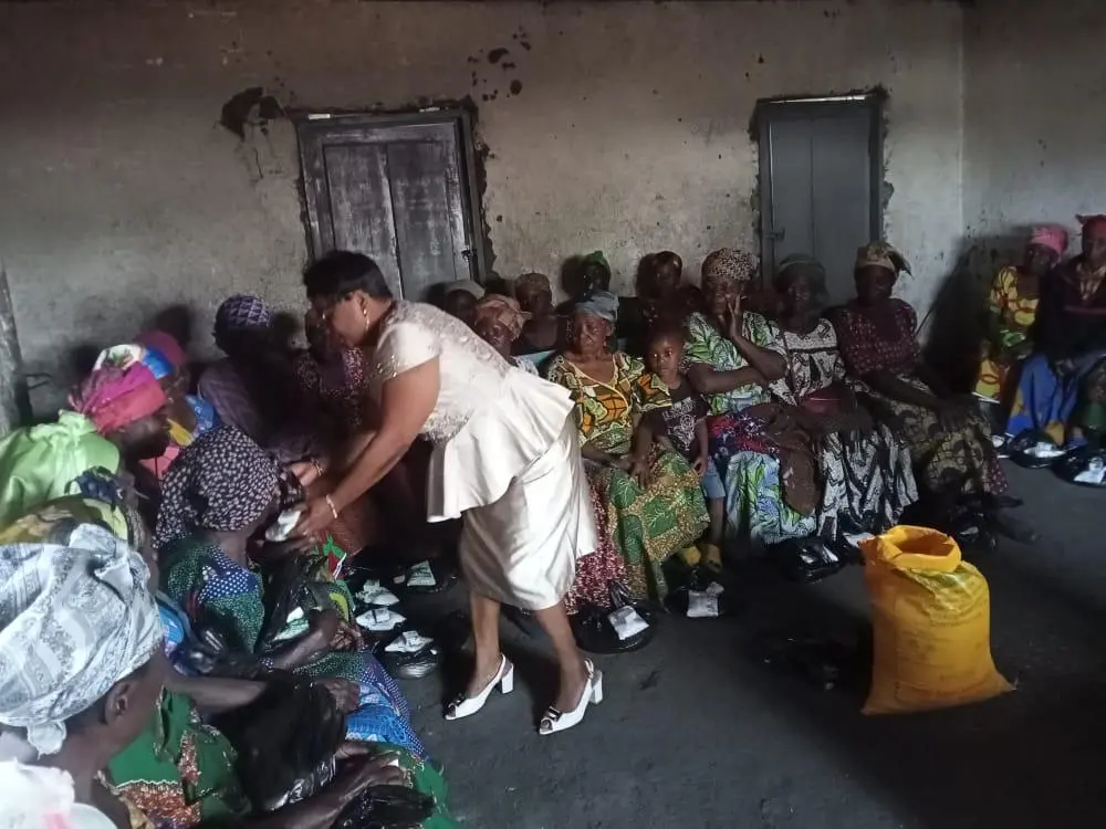 Widows receiving shoes and supplies