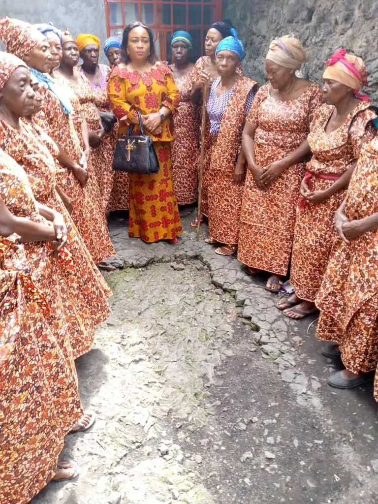 Elderly widows gathered in orange print dresses